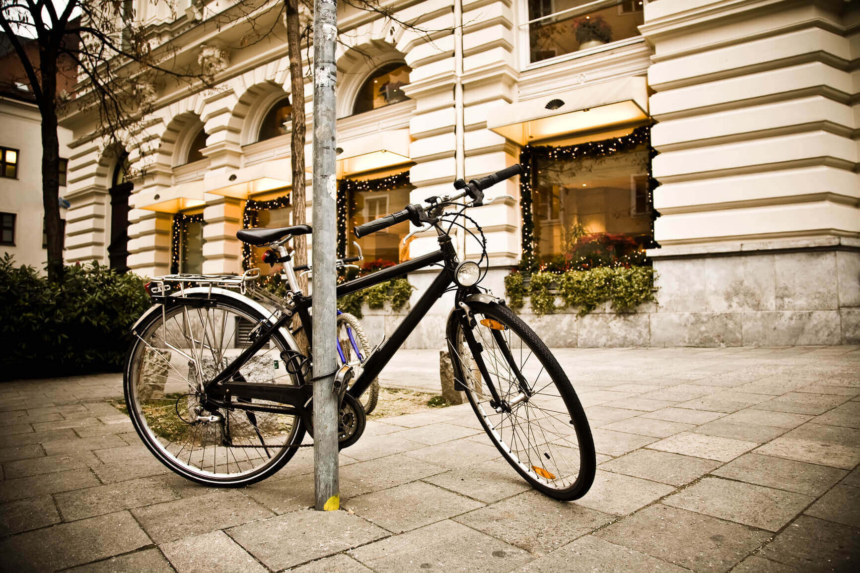 Black bicycle parked in front of building.