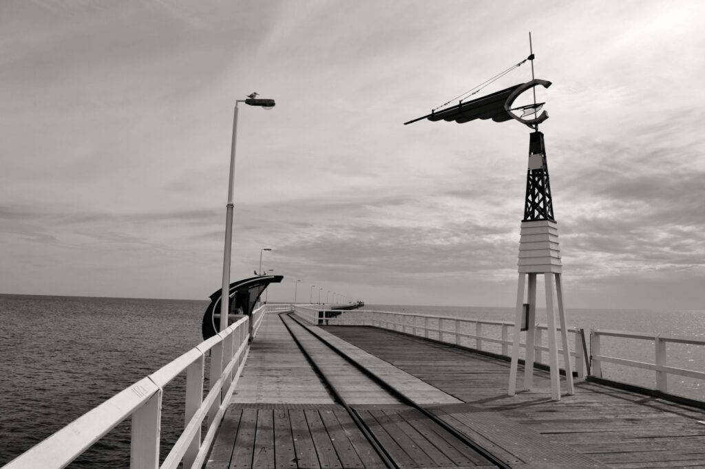 Wooden pier extends to the sea.
