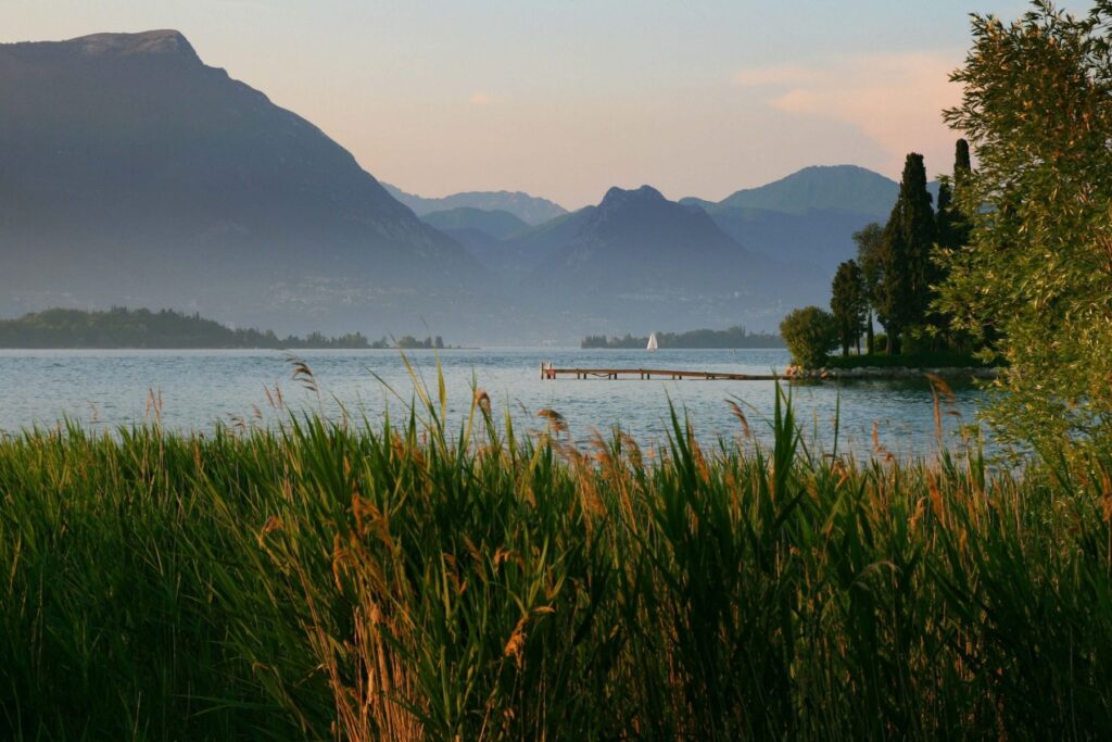Lake view with mountains and a dock.