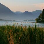 Lake view with mountains and a dock.