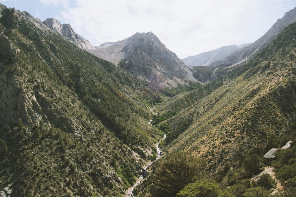 Mountain valley with a stream flowing through it.