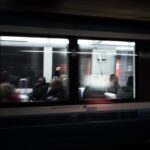Blurred view of passengers on a train.